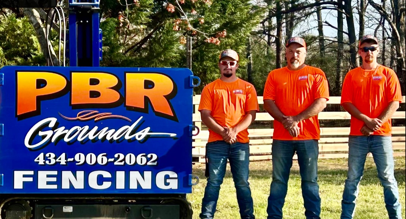 The PBR Grounds crew beside their hydraulic post driver